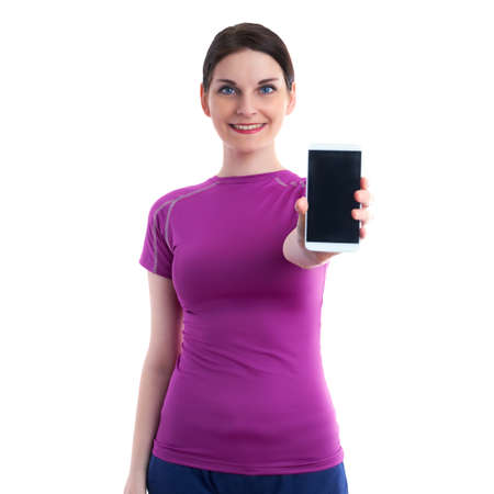 Smiling sporty woman in violet T-short showing something on smart phone device over white isolated background, fitness, sport, technology and lifestyle conceptの写真素材