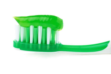 Green single toothbrush with paste isolated over white backgroundの写真素材
