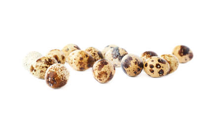 Heap of quail eggs isolated over white backgroundの写真素材
