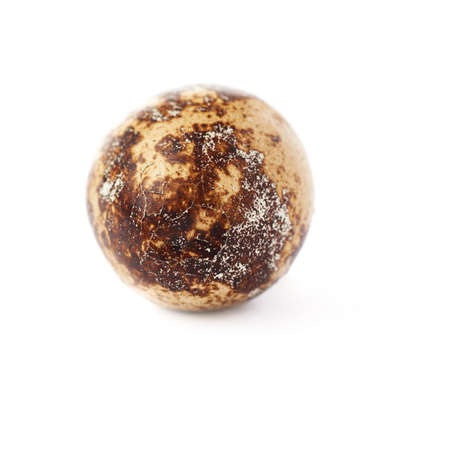 Single cracked quail egg isolated over white backgroundの写真素材