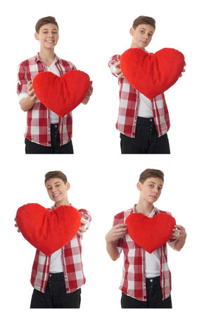 Cute teenager boy in red checkered shirt with plush heart over white isolated background, half bodyの写真素材