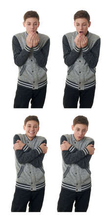 Cute teenager boy in gray sweater heating hands over white isolated background, half bodyの写真素材