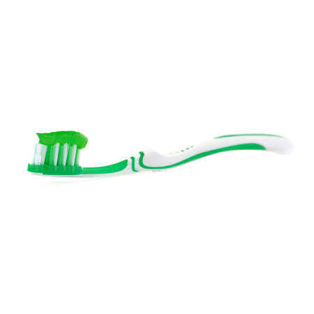 Green single toothbrush with paste isolated over white backgroundの写真素材