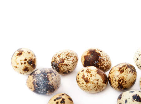 Heap of quail eggs isolated over white backgroundの写真素材