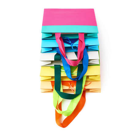 Pile of colorful shopping or gift bags isolated over the white backgroundの写真素材