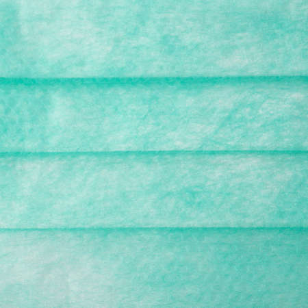 Green medical surgical flu illness protective mask texture as abstract backgroundの写真素材
