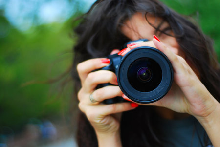 Beautiful photographer and her digital camera