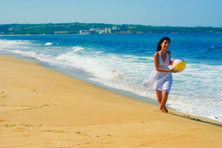 Playing with a ball at the beachの写真素材