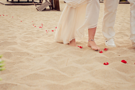 Beach wedding bride and her father are walkingの写真素材