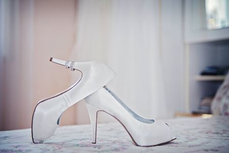 White shoes and ring of the Bride . wedding theme backgroundの写真素材