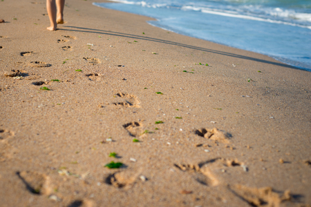 Child is jumping on the beach. Sand and sea in Bulgaria, Europa.の写真素材