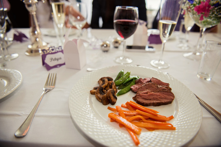 Main course menu with beef, carrots, beans and mushrooms freshly served on a white plate. Main course for Hotel, restaurant or pension.の写真素材