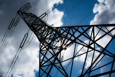 Power line tower with clouds and a blue skyの写真素材