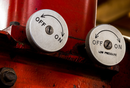 Vintage antique automotive machine shop hydraulic press pressure valve dials on a red pressの写真素材