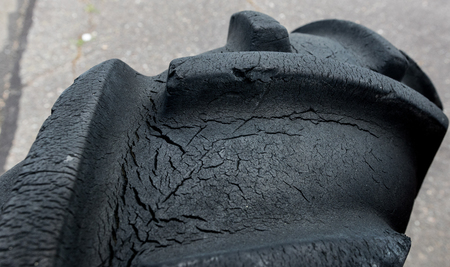 Vintage antique automotive tractor wheel with cracks and traction grooves.の写真素材