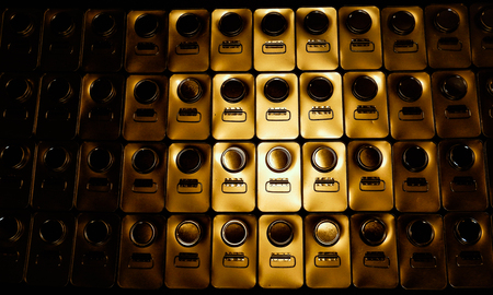 Abstract metal 1 gallon cans with a yellow reflection and dark edgesの写真素材