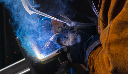 Man tig welding steel cast plates with brilliant bright white star burst bloom of lightsの写真素材