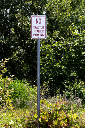 No tractor trailer parking sign against many bushes and shrubsの写真素材
