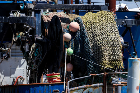 Fishing net and float reel mounted on a vessel reeled inの写真素材