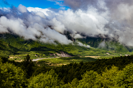 Mt. St. Helens area foggy cloudy forest valley with river and bankの写真素材