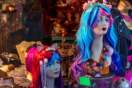Curio antique shop window displaying mermaid wigs in the windowの写真素材