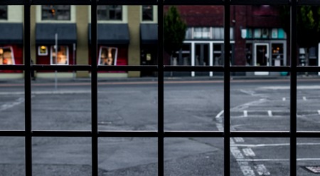 Wrought iron fence abstract with retail buildings blurred in the backgroundの写真素材