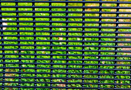 Abstract bench back grid with grass and brown leavesの写真素材