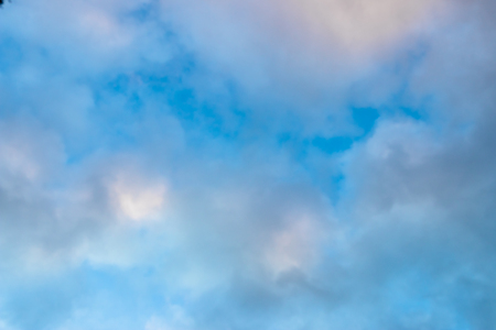 Medium dark clouds against a blue sky in an appealing patternの写真素材
