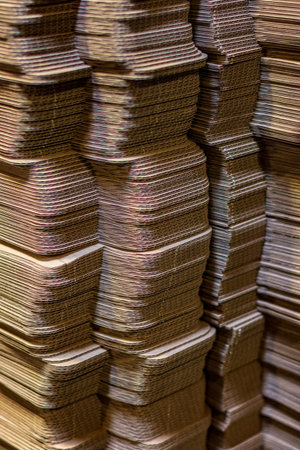 Corrugated cardboard boxes flattened stacked in rows