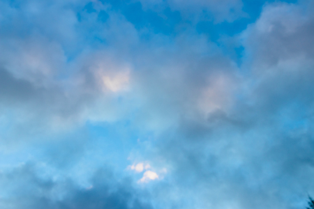 Medium dark clouds against a blue sky in an appealing patternの写真素材