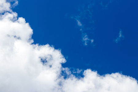 Light fluffy clouds against a blue sky in the summerの写真素材