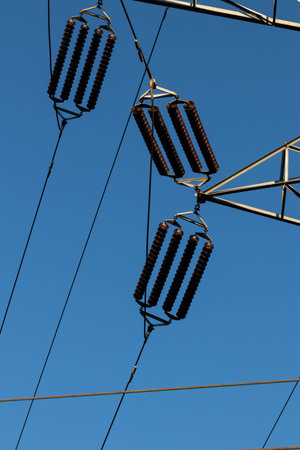 Power line insulators on a blue sky in daylight