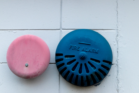 Abstract building wall with antique fire alarms in daylightの写真素材