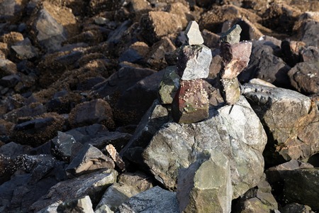 River stones piled in stacks balanced in daylightの写真素材