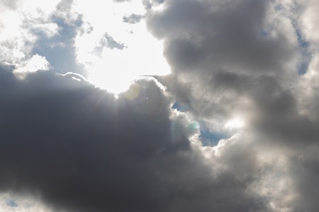 Heavy dark clouds with sunlight highlights and deep shadowsの写真素材