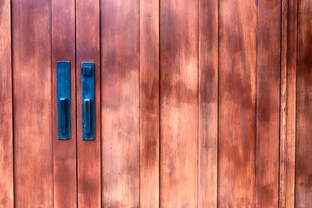 Antique building double doors with faded paint in daylightの写真素材