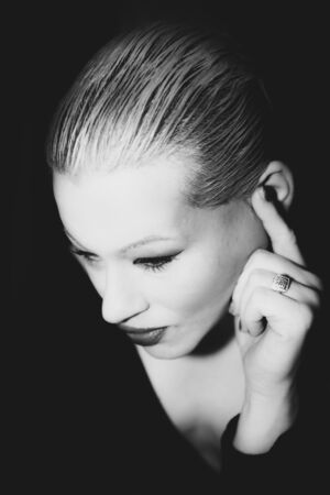Classic timeless elegant model posing for vintage shoot in black and whiteの写真素材