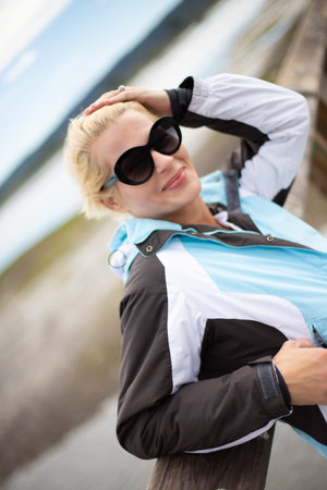 Pretty woman posing on a boardwalkの写真素材