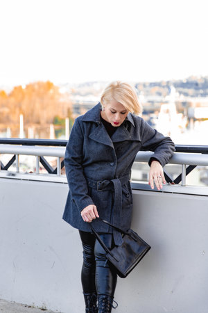 Fashionable blonde woman walking exploring the cityの写真素材