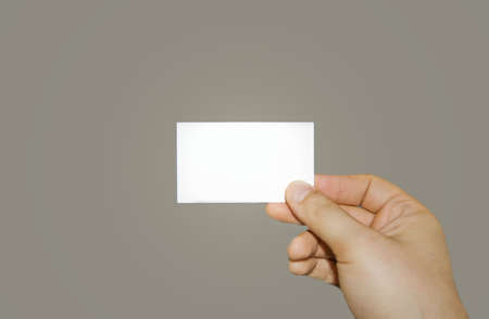 a man holding a white business cardの写真素材