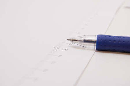 measuring tape with a pen on white backgroundの写真素材