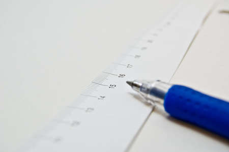 measuring tape with a pen on white backgroundの写真素材