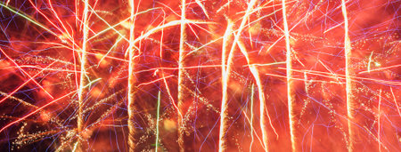 Colorful fireworks over dark sky, displayed during a celebration