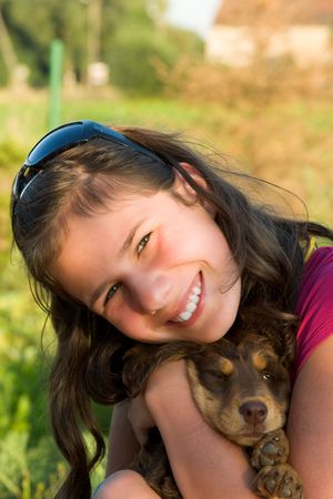 Young girl with small little dog on hands の写真素材