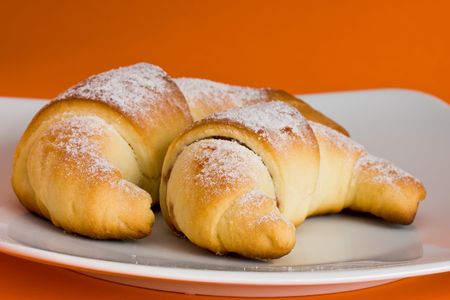 Two croissant with marmolade and sprinkled with sugarの写真素材