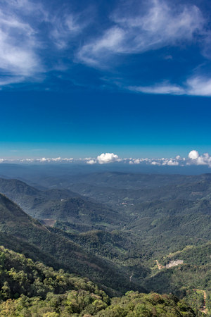 blue sky above vagamon valley kerala toughing the horizon with little cloud makes an awesome natural view.の写真素材