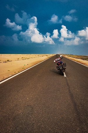 Motorcycle standing on road with life message and left space for you to write something about your experience.の写真素材