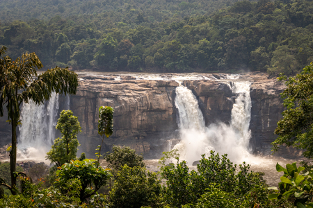 This is the athirapally waterfall kerala india in the middle of the western ghat range. It is falling from 80 mtrs high hill and it is the second largest waterfall in india. Image is taken from distance.の写真素材