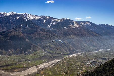 Paragliding in snow cap mountains of himalayas image is taken at manali india showing its amazing natural view.の写真素材
