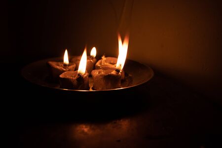 traditional religious soil made oil lamp many lightened for almighty godの写真素材